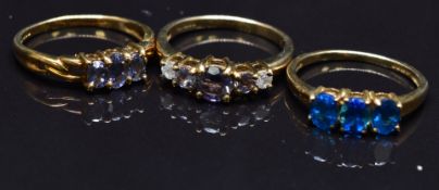 Three 9ct gold rings set with tanzanite, diamonds, paste, etc, size N, 6.3g