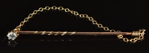 A 9ct gold stick pin set with a diamond, 1g