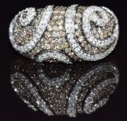 A 9k gold ring set with champagne diamonds and diamonds in a swirling design, size N, 5g