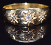 An 18ct gold ring set with three diamonds in star settings, Birmingham 1913, size M, 2.8g