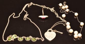 A silver necklace set with peridot, silver necklace set with pearls, a silver necklace marked