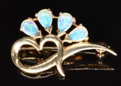 A 9k gold brooch set with pear cut opals, 2.9g