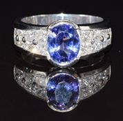 An 18ct white gold ring set with a tanzanite of approximately 1.5cts and eight princess cut diamonds