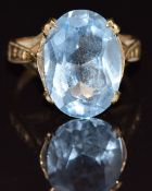 A 9ct gold ring set with an oval cut topaz, size J, 3.8g