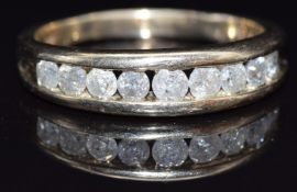 A 9ct gold ring set with nine round cut diamonds, size V, 5.4g