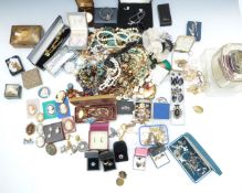 A large collection of costume jewellery including vintage brooches, amethyst and pearl necklace,