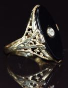 An 18ct gold ring set with onyx and a diamond to the centre, size P, 6g