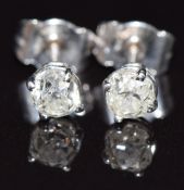 A pair of 18ct white gold earrings set with an old cut diamond of approximately 0.3ct to each, 1.1g