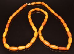 A single strand of oval Baltic amber beads, 69g