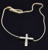 An 18ct gold cross pendant set with 15 round cut diamonds and an Asscher cut diamond, total
