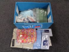 A box of new and un-worn clothing, shirts,