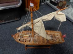 A wooden masted boat on stand CONDITION REPORT: height 48 cm length 57 cm width 18