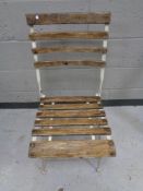 A folding metal wooden slatted garden chair