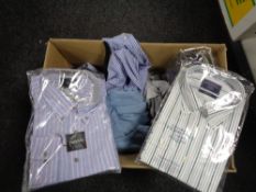 A box of new clothing including shirts,