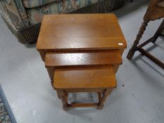 A nest of three oak tables