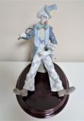 A Lladro figure of a clown with magnifying glass on plinth CONDITION REPORT: Top of