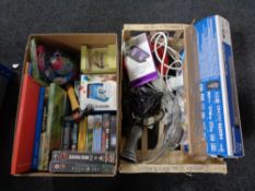 A box of household sundries including extension leads, portable sanitizer, books, video tapes,