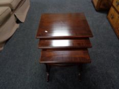 A nest of three mahogany tables