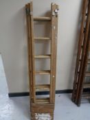 A wooden triple section extension ladder
