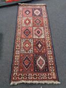 A Caucasian runner of compartmentalised design,