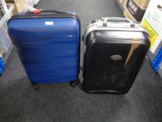 A hardshell luggage case , in new condition and one further similar case.