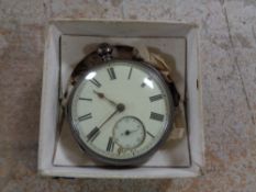 A silver pocket watch with key