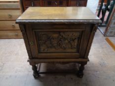 A mid century carved oak storage cabinet