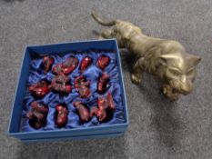 A brass tiger ornament and a set of carved resin figures