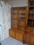 A mid century teak double door bookcase