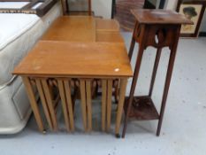 A twentieth century teak table fitted with four beneath together with an Edwardian plant stand