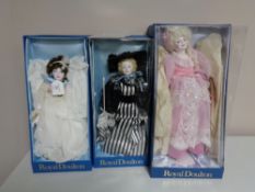 Three Royal Doulton Nisbet Collection dolls in boxes.