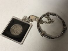 A Sterling silver designer bangle, together with a silver half dollar and curb bracelet.