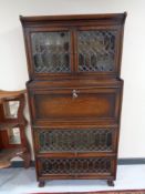 An Edwardian oak bureau sectional bookcase with leaded glass doors