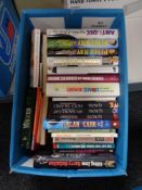 A box of books including Paul O'Grady,
