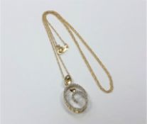 A 10ct gold 'Mother and Child' diamond set pendant on yellow gold chain.