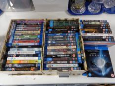 Two boxes of blu-ray discs, some sealed.