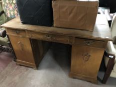 An early twentieth century oak pedestal desk