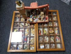 A collection of teddy bear figures in two display cases and a further display stand with miniature