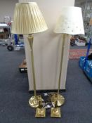 A pair of brass finished floor lamps together with a pair of brass table lamps