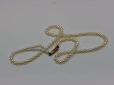 A 16 inch strand of pearls on a yellow gold clasp