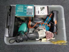 A crate of tools, disc sander,