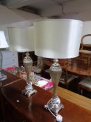 A pair of contemporary glass and metal table lamps