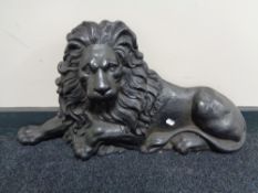A Victorian cast iron door stop modelled as a recumbent lion CONDITION REPORT: Some