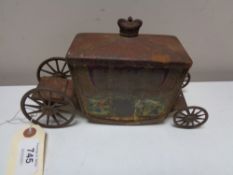 An antique Jacobs biscuit tin in the form of a state carriage