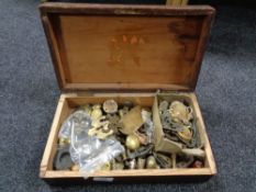 A pine box containing brass and other furniture parts, door escutcheons, handles,