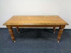 A Victorian oak table on ceramic casters