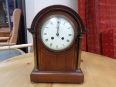 An Edwardian inlaid mahogany bracket clock with brass pillar supports