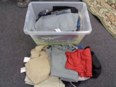 A crate of new and un-used clothing, trousers,