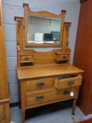 A late Victorian walnut mirror door wardrobe with matching dressing table