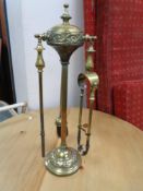 A brass three part fire companion set
